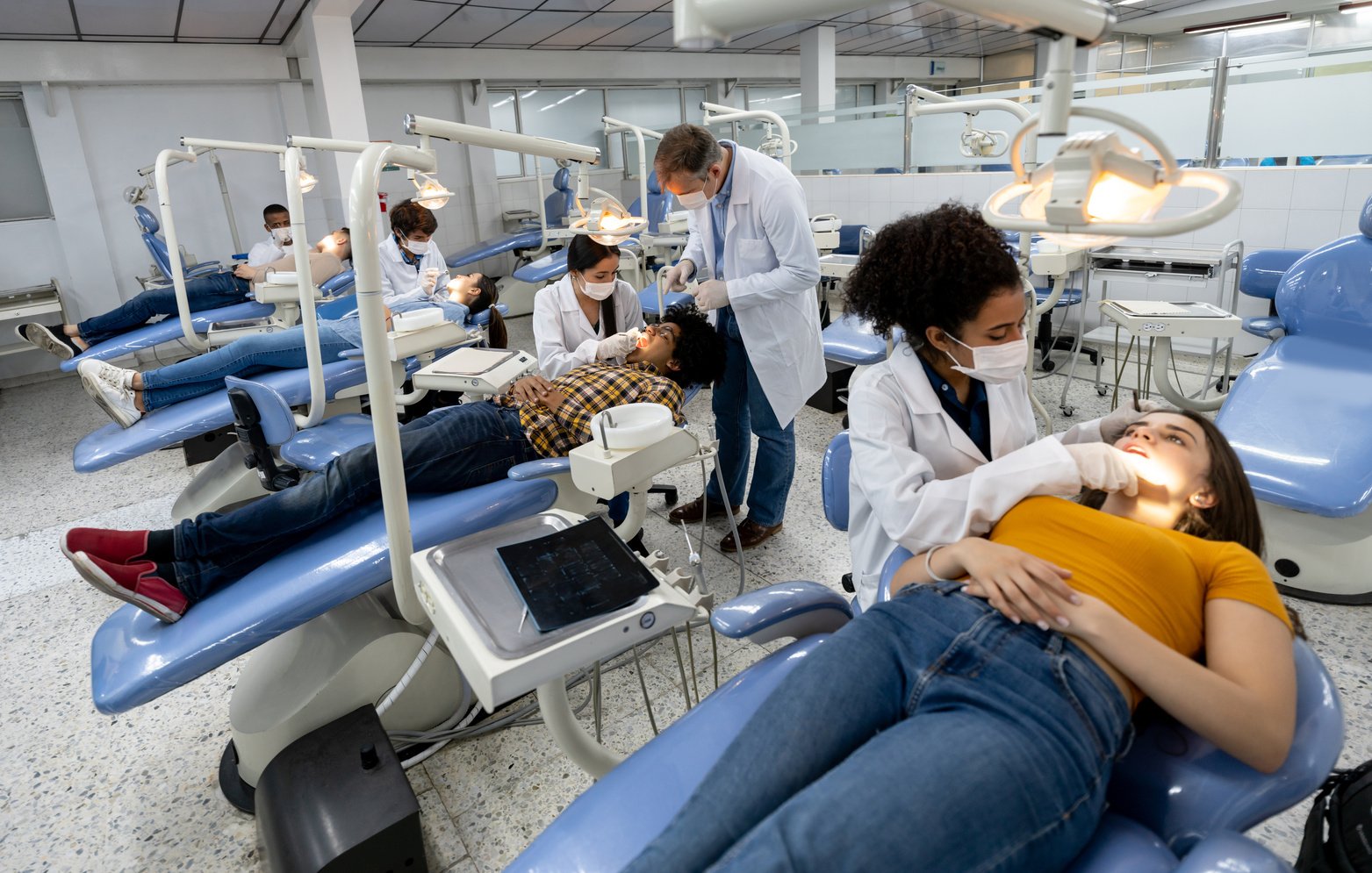 Students at dental school examining patients